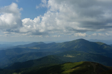 Fototapeta premium clouds over the ukrainian carpathian mountains view from hoverla peak highest in the country with green beautiful valleys in summer 