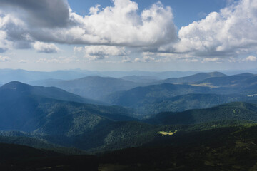 Fototapeta premium clouds over the ukrainian carpathian mountains view from hoverla peak highest in the country with green beautiful valleys in summer 