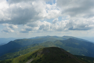 Fototapeta premium clouds over the ukrainian carpathian mountains view from hoverla peak highest in the country with green beautiful valleys in summer 