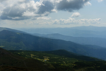 Fototapeta premium clouds over the ukrainian carpathian mountains view from hoverla peak highest in the country with green beautiful valleys in summer 
