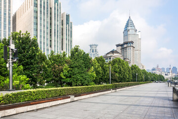 Modern Urban Walkway with Tall Buildings and Green Trees