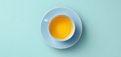 The elegant tea cup showcasing vibrant yellow herbal beverage on a pastel background.