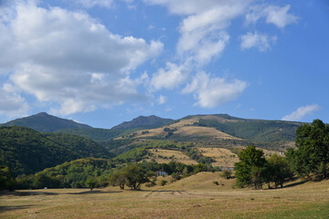 Obraz premium beautiful mountain landscape forest nature stones summer blue sky clouds