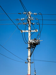 Clear Blue Sky Overhead with Electrical Power Pole and Cables