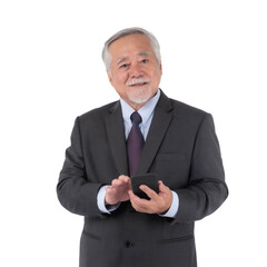 Senior Asian businessman in formal dark suit holding smartphone with smiling confident expression, elderly professional using mobile device isolated on a transparent background, business concept