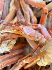 Frozen king crab claws in the freezer for sale in the supermarket. Delicatessen meat for a healthy diet. Close-up