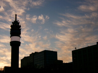 Sunset and silhouette of Chile's largest telephone tower next to business buildings