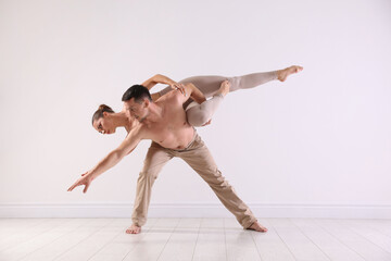 Couple of professional dancers training in studio