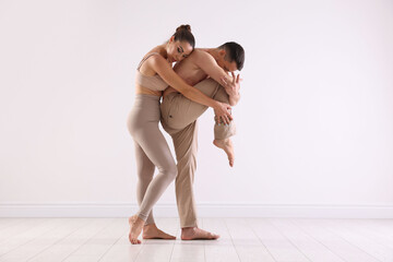 Couple of professional dancers training in studio