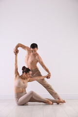 Couple of professional dancers training in studio