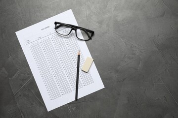 Student passing exam. Answer sheet, glasses, pencil and eraser on gray textured table, flat lay....