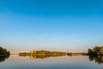 A confluence of Narew (left) and Vistula (right) rivers with lush green banks.