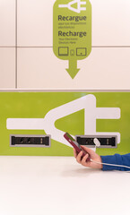 I charge my device at a charging point at the airport.