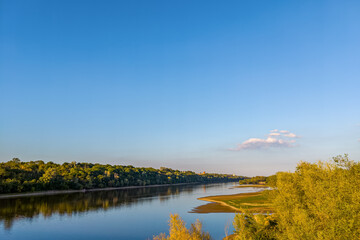 High angle view of a confluence of Narew (left) and Vistula (right) rivers with lush green banks.