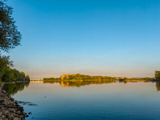 A confluence of Narew (left) and Vistula (right) rivers with lush green banks.