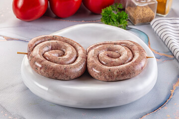 Raw meat pork and beef swirl sausages