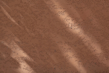 Wall with texture and shadows. Orange, brown concrete background