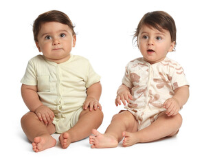 Cute little twin babies on white background