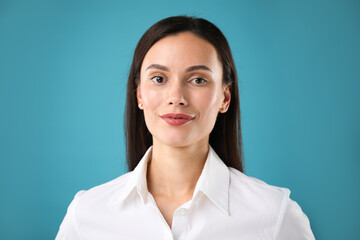 Portrait of confident businesswoman on blue background