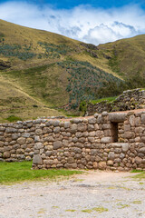 Fototapeta premium Archaeological Site in Cusco, Peru Surrounded by Lush Green Vegetation