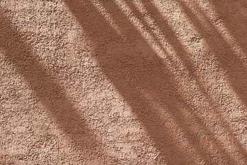 Wall with texture and shadows. Orange, brown concrete background