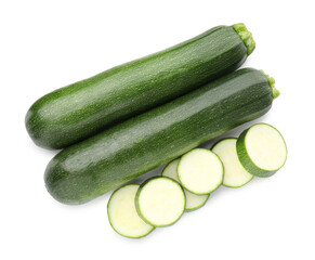 Whole and cut fresh zucchinis isolated on white, top view