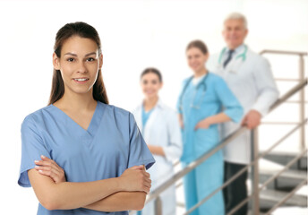 Medical assistant and other healthcare workers in hospital, selective focus