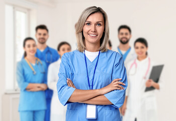 Medical assistant and other healthcare workers in hospital, selective focus