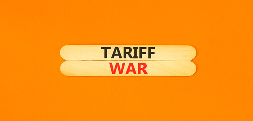 Trade tariff war symbol. Concept word Tariff war on beautiful wooden sticks. Beautiful orange paper...