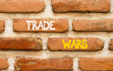 Trade wars symbol. Concept word Trade wars on beautiful old brown brick wall. Beautiful old brown brick wall background. Old brick wall. Business trade wars concept. Copy space.