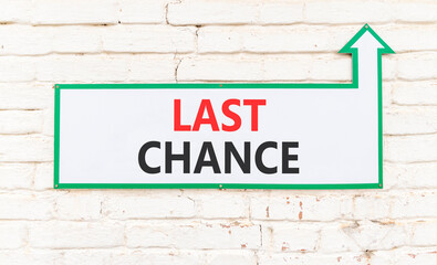 Last chance symbol. Concept word Last chance on beautiful white sign on white brick wall. Beautiful...
