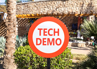 Tech demo symbol. Concept word Tech demo on beautiful red and white road sign. Beautiful palm tree...