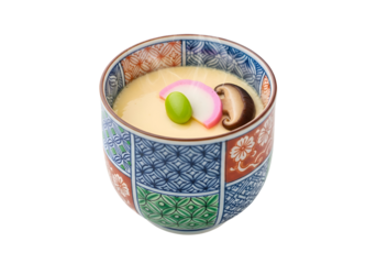 A delicate, light-colored egg custard dish, presented in a decorative bowl with vibrant floral and geometric patterns, showcases a colorful array of garnishes.