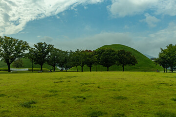 Silla Dynasty burial hills, or tumuli, are large earthen mounds in Gyeongju, the Silla kingdom's...