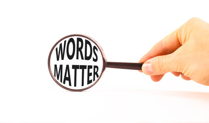 Words matter symbol. Concept word Words matter on beautiful magnifying glass. Businessman's hand....
