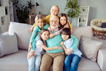 Photo of happy positive smiling good mood family grandfather babysitting little children hug...