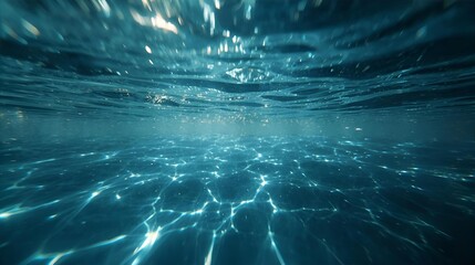 Underwater view of rippling water surface and light patterns