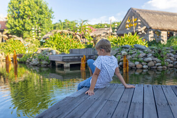 Happy european family, visting Hoi An city in Vietnam for a summer vacation, trying traditional food na watching the show in Memories Land