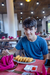 Happy european family, visting Hoi An city in Vietnam for a summer vacation, trying traditional food na watching the show in Memories Land