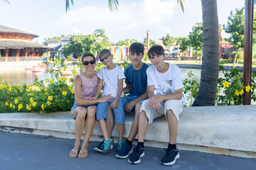 Happy european family, visting Hoi An city in Vietnam for a summer vacation, trying traditional food na watching the show in Memories Land