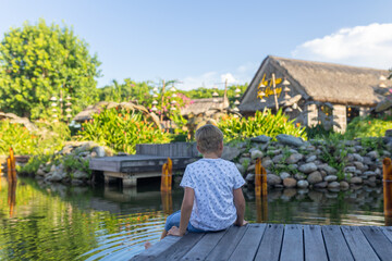 Happy european family, visting Hoi An city in Vietnam for a summer vacation, trying traditional food na watching the show in Memories Land
