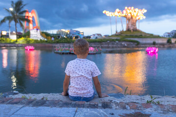 Happy european family, visting Hoi An city in Vietnam for a summer vacation, trying traditional food na watching the show in Memories Land