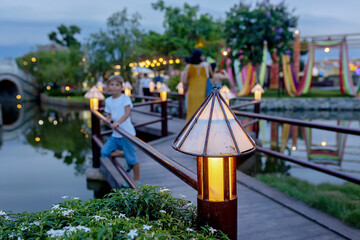 Happy european family, visting Hoi An city in Vietnam for a summer vacation, trying traditional food na watching the show in Memories Land