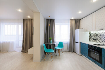 Bright modern interior with an open-plan kitchen and living area. Features include light wood...