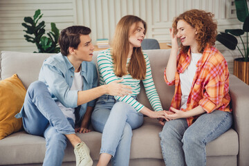 Friends offering comfort and support during an emotional conversation in a cozy living space with natural lighting