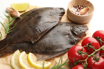 Fresh raw flounder fish and ingredients on white table, above view. Seafood