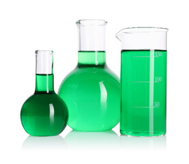 Flasks and beaker with green liquid on mirror surface isolated on white