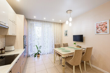 bright, tidy kitchen and dining area with modern furnishings, including a dining table, chairs,...