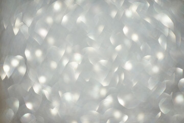 Abstract soft light pattern with glowing white shapes creating a dreamlike blurred effect.