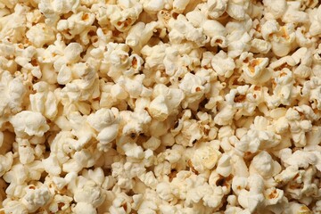 Fresh tasty popcorn as background, closeup view